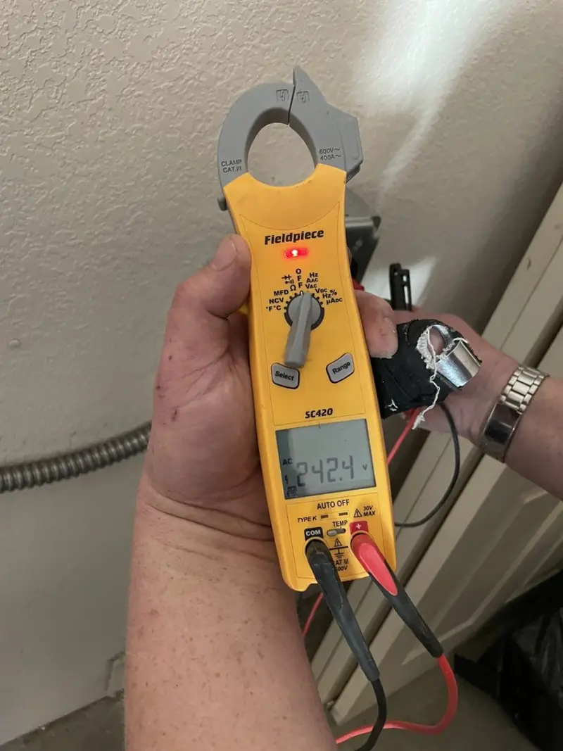Voltage testing with clamp meter during Outlet Installation in Minot